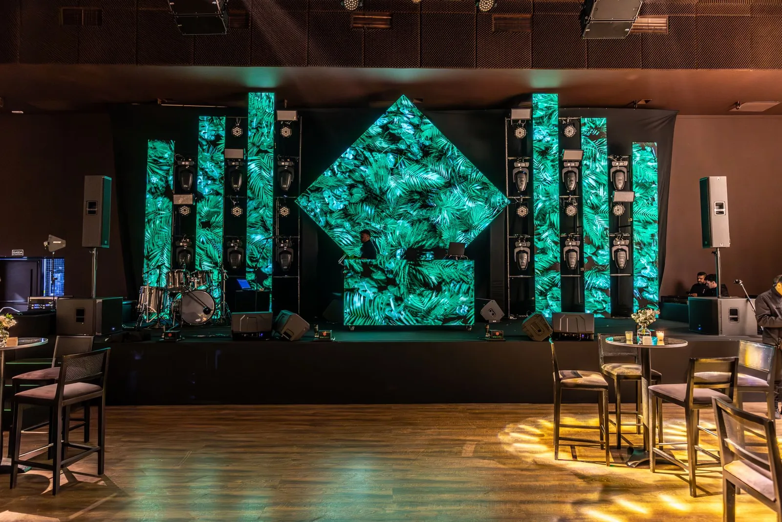 Installed stage LED panels displaying green visuals