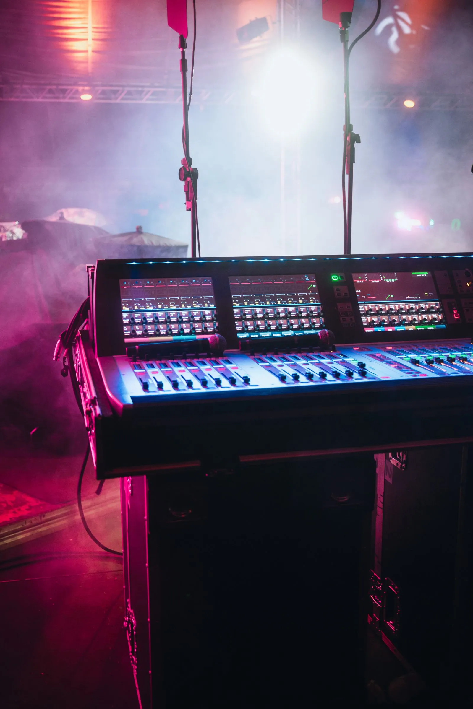 Professional audio mixing console at an event stage